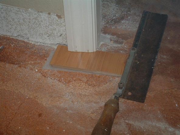 Under cutting door jambs with a hand saw, before installing laminate flooring