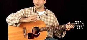 Hold an acoustic guitar with correct playing posture