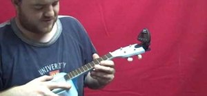 Tune a ukulele using a digital tuner