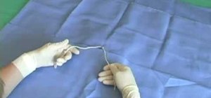 Perform left handed two hand suture ties on an animal