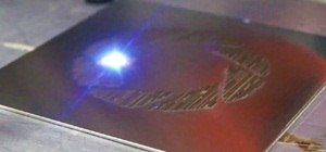 Fiber Laser Scores Aperture Logo in Steel While Playing Portal's "Still Alive" Theme Song