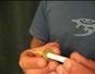 Push a cigarette through a coin trick
