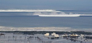The oncoming tsunami strikes the coast in Natori City, Miyagi Prefecture, nort