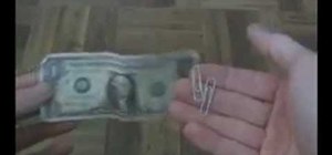 Link two paper clips together using a folded dollar bill