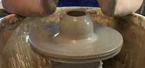 Throw the body of ceramic mug on the potter's wheel