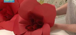 Crafter supersized red paper flowers for Christmas