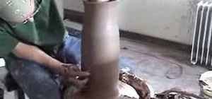 Throw a large clay vase on a pottery wheel