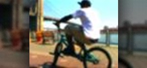Perform a fakie rollback on a BMX bicycle