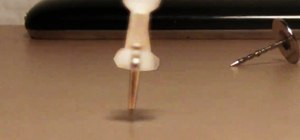 Turn a plain thumbtack into a spinning top