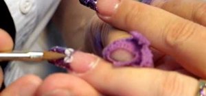 Paint white flowers on glittery purple nail tips