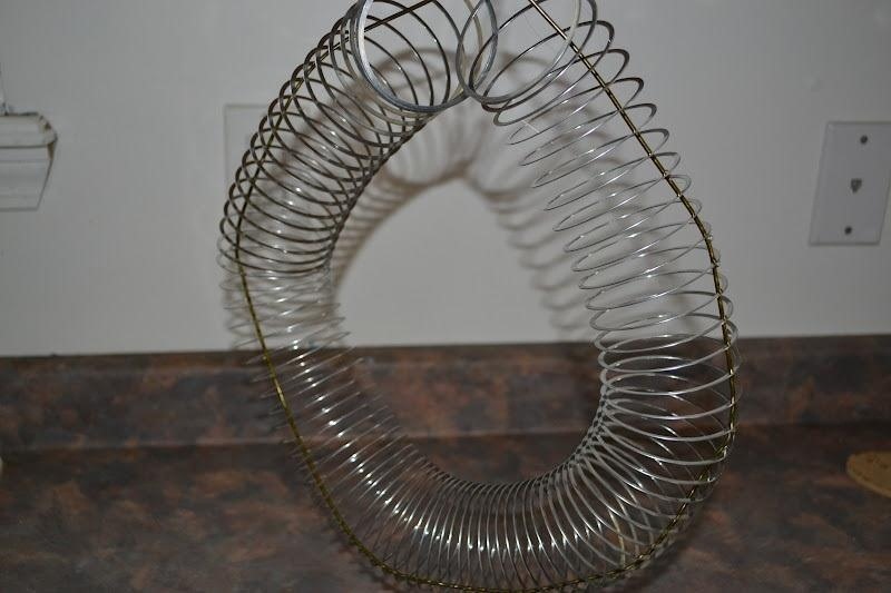 How to Turn an Old Metal Slinky and Coat Hanger into a Bird Feeder
