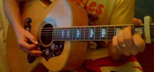 Play "Julia" by The Beatles on acoustic guitar