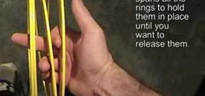 Learn to hold three rings in one hand for juggling
