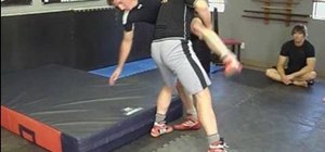 Perform an outside single leg to double (knee tap) in wrestling