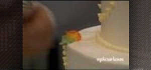 Decorate a wedding cake with leaves and roses
