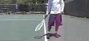 Pick up tennis balls with your foot and racquet