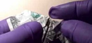 Fold a heart shaped ring out of a dollar bill