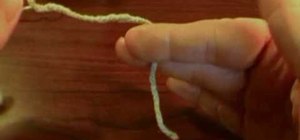 Hold a hook and yarn in crochet