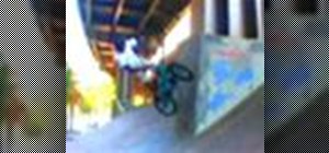 Perform a walltap barspin on a BMX bicycle