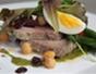 Make a classic tuna Niçoise salad with tomatoes, olives and herbs