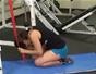 Do a resistance band crunching exercise while kneeling