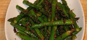 Cook asparagus with ginger in a pan by Manjula