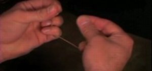 Perform the torn and restored rubber band magic trick