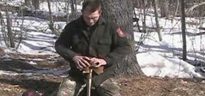 Start a fire with the "fire saw" friction method
