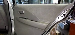 Remove the inside rear door panel on a Nissan Altima