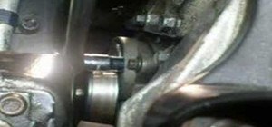 Remove the serpentine belt tensioner in a Saturn car