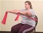 Do a seated chest press exercise with resistance bands