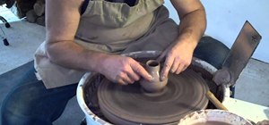 Throw a ceramic bottle or bud vase on a pottery wheel