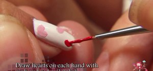 Create a rhinestone-studded cherries and hearts nail look