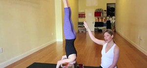 Perform a yoga tripod headstand pose