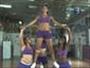 Do a thigh stand stunt in cheerleading