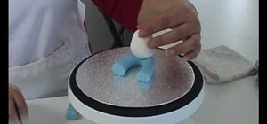 Make a person out of sugar paste or ready to use icing