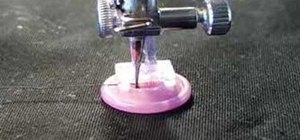 Sew on a button using the Singer sewing machine