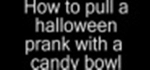 Prank trick or treaters with a candy bowl and hand