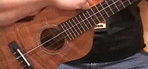 Strum the ukulele with your right hand