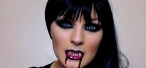 Apply costume vampire makeup for Halloween