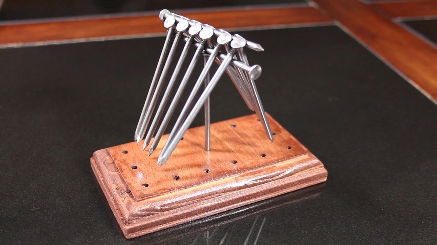 How Do You Balance 14 Nails on a Single Nailhead? Find Out with This DIY Gravity Puzzle