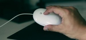 Clean the scroll ball on an Apple Mighty Mouse with a sheet of printer paper