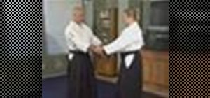 Execute the Aikido double wrist grab