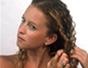 Create a braided, half-up hairstyle for curly hair