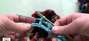 Use a loom and crochet hook to make a flower scarf