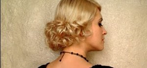 Create an elegant low curly bun hairstyle for a wedding