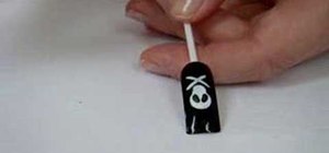 Paint nails with a skull and crossbones