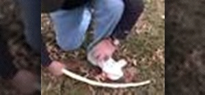 Make a bow drill fire using a spindle and fireboard