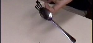 Balance a fork and a spoon on a toothpick