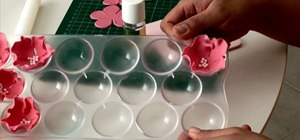 Make a delicate rose out of fondant for cake decorating